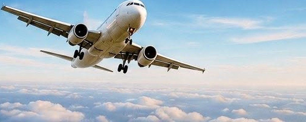 A passenger jet flying above the clouds